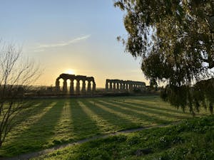 The ancient Appian Way in Rome, lined with historic ruins and greenery